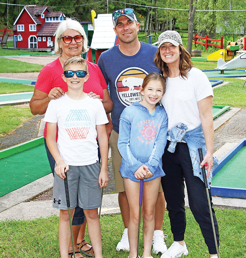 Jesse, Tracy, Evan, Anya and Terry Troestler were giving mini golf a try.