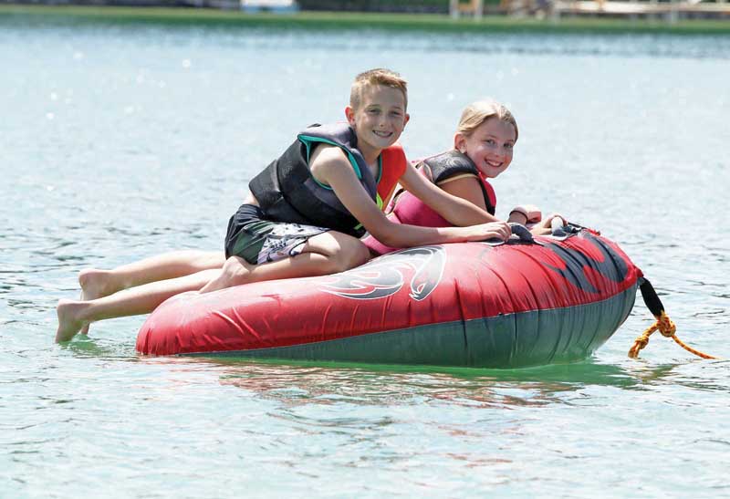 Maddex and Maelin Wood were all smiles as they got ready to ride their tube on Round Lake.