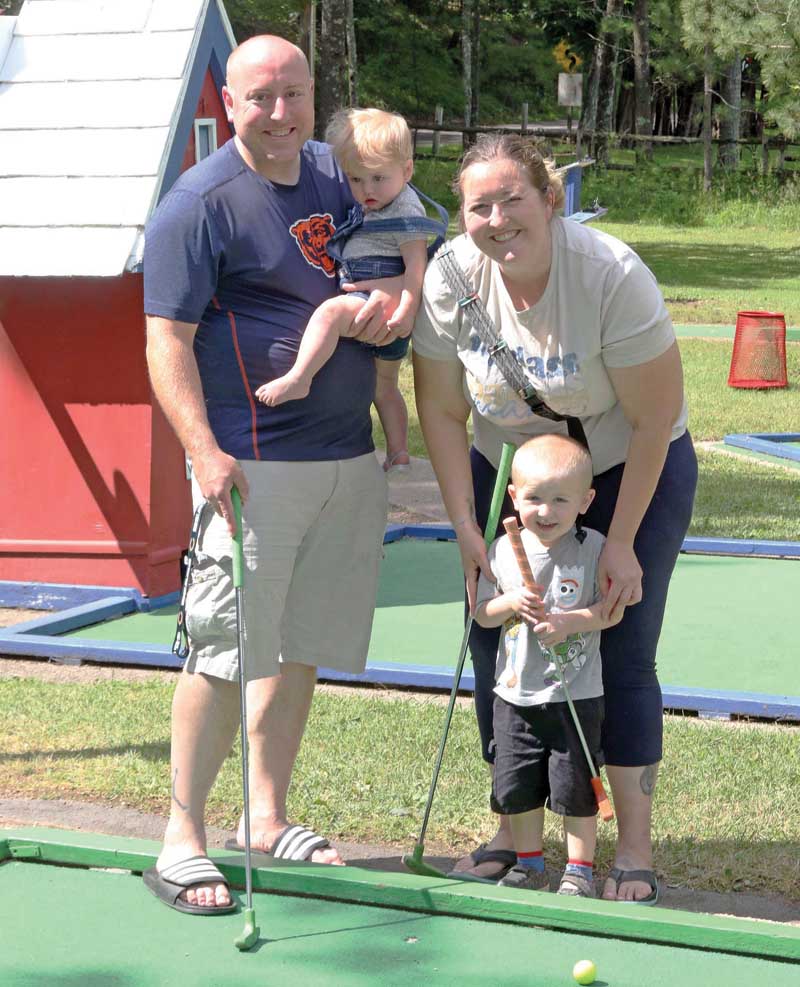 Peyton Alshanski, of Illinois, was playing his first game of mini golf with his parents Amanda and Jason, and little sister Ryleigh.