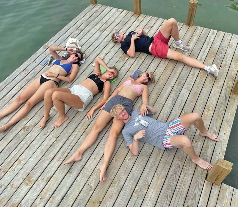 Cousins Morgan, Brooklyn, Natalie, Cole and Tristan from Hartland, Oshkosh and Waupaca, take a rest on the dock after lunch.