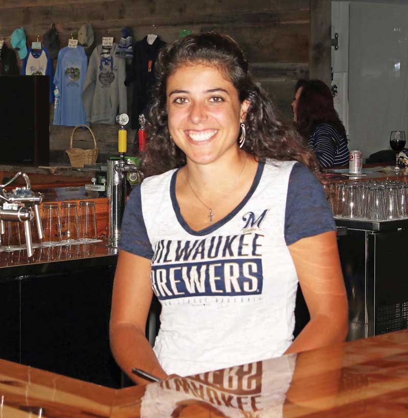 Jane Beyer, one of the co-owners of Rio Lobo, is all smiles as she tends bar at the establishment.
