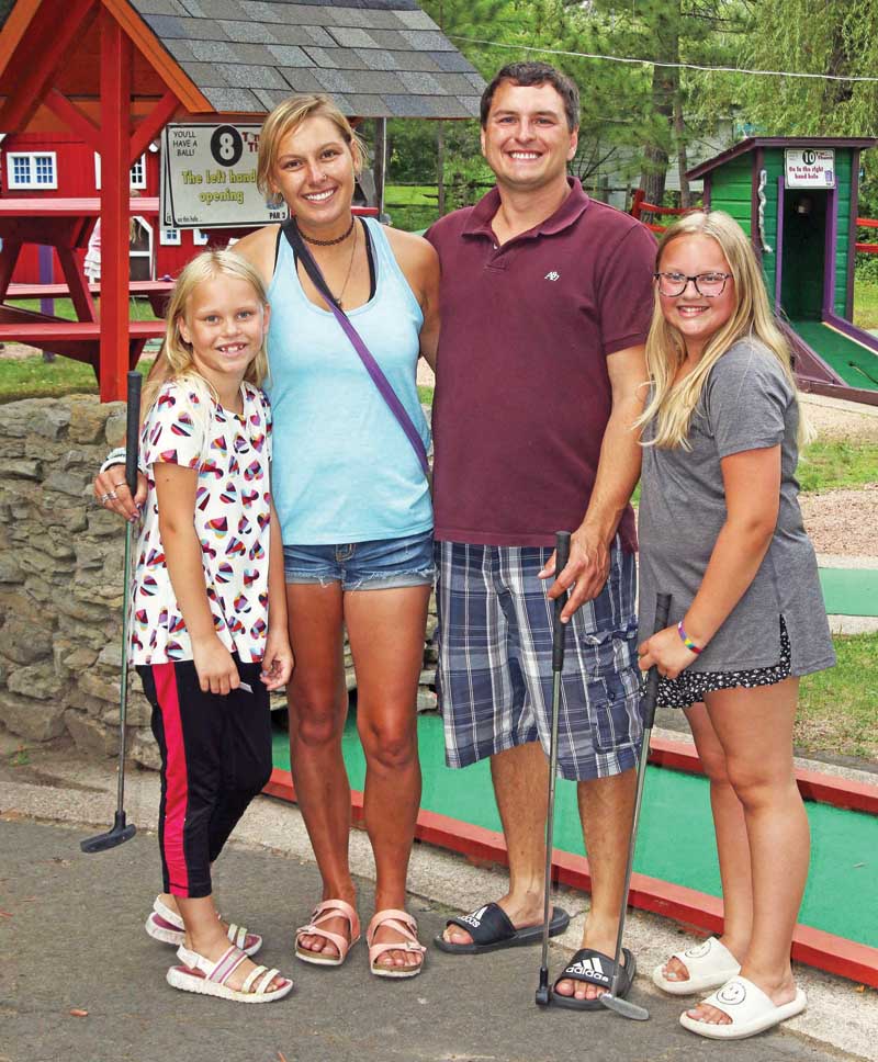Kailyn Pospichal, Nicholas Schulke and Grace and Emily Gabrielson enjoy a game of mini golf.