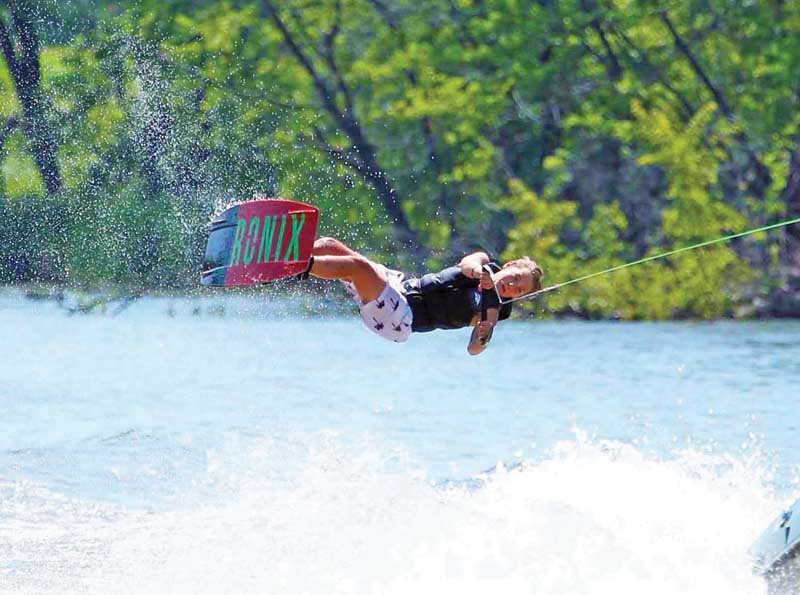 Nathan Fiedorowicz pulls off a back roll on his wakeboard.