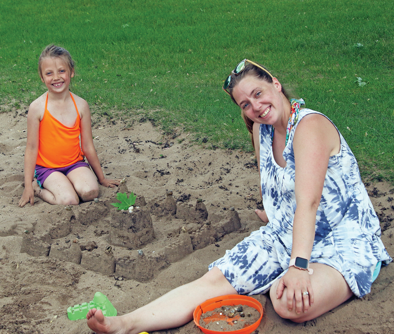 Nora Werth and her mom were having fun making sandcastles.