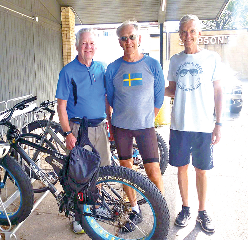 The Johnson brothers, Dave, Jeff and Clark, tour Waupaca on their bikes.