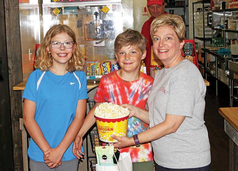 Alaina, Riley and Amy Koehler could not wait to dig into their big bucket of popcorn!