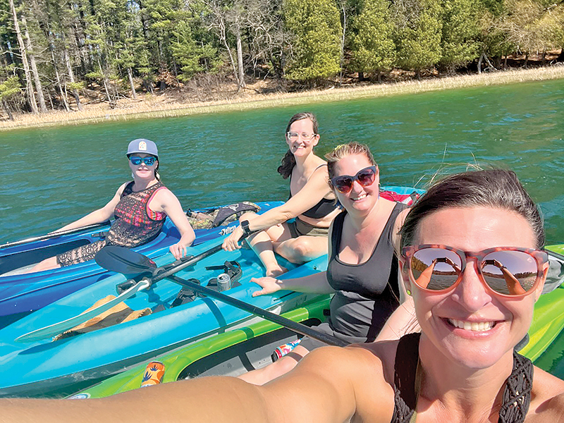 Erin Mahoney, Delaney Schroeder, Sam Holtane and Brynn DeHay celebrate a birthday by kayaking the upper chain during the 80 degree weather on April 12.