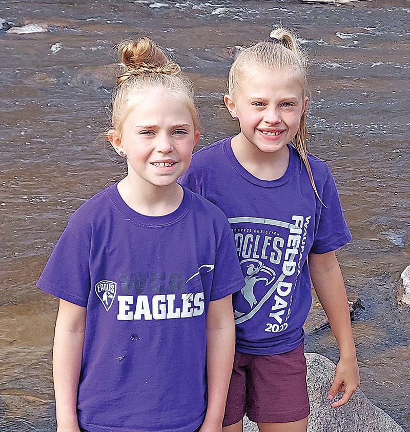 Izzy and Lily Adams took advantage of the beautiful weather to cool off in the river.