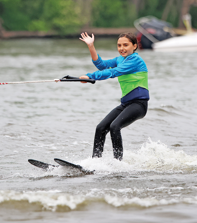 Aaliyah Sorge waves to the crowd during the Webfooters Ski Show in Fremont.