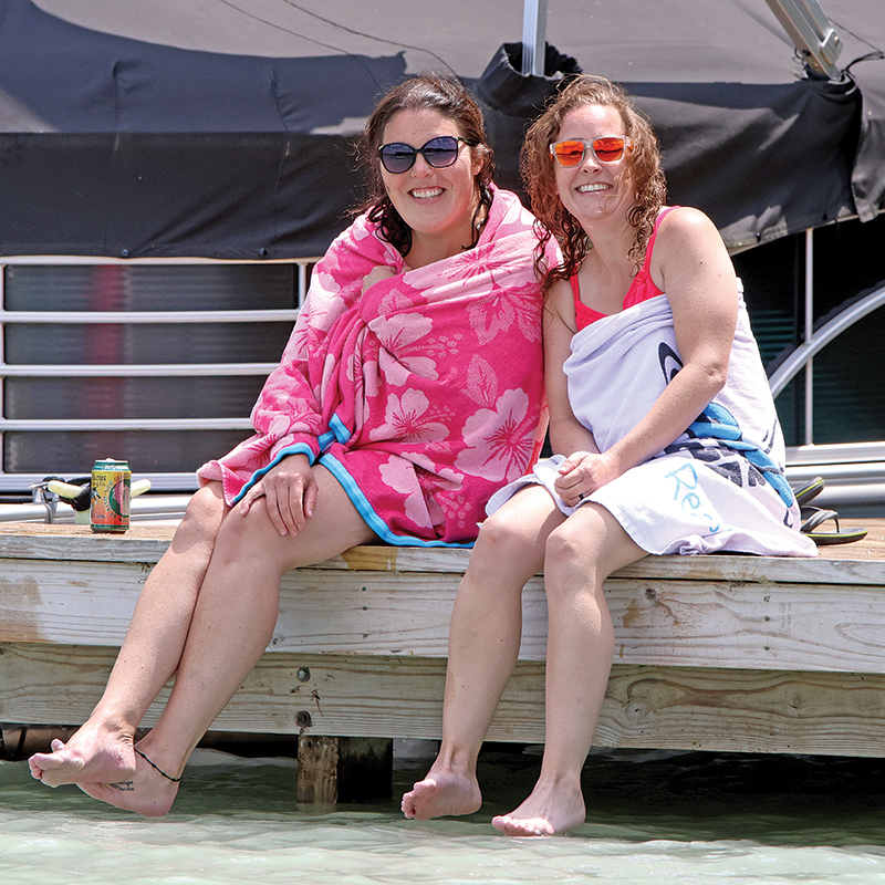 Mindy and Stacy flash their smiles while relaxing on Lime Kiln Lake.