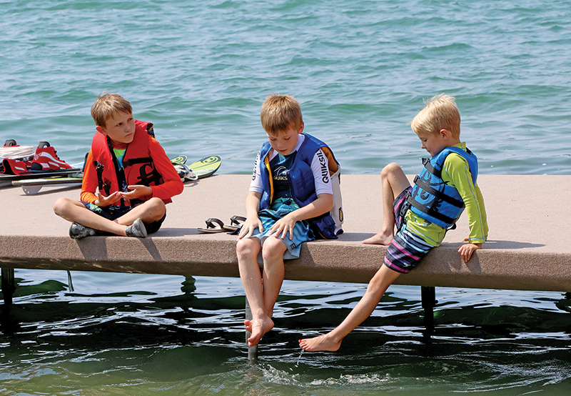 Waupaca Chain Skiers Jacob Dykstra, Jace Meyers and Wesley Dykstra relaxing on the dock before the show.