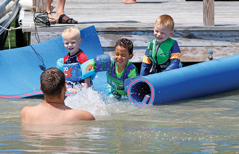 William, Zani and Josiah were having fun trying to splash someone while on Sunset Lake.