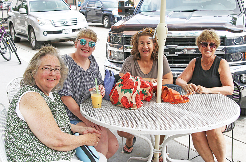 Jeanie Werning, Diana Kraus, Carrie Crockatt and Mickey Collura were dining outdoors on a summer day.
